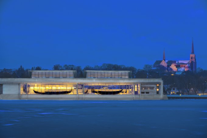 The Viking Ship Museum in Roskilde, with Roskilde Cathedral in the background